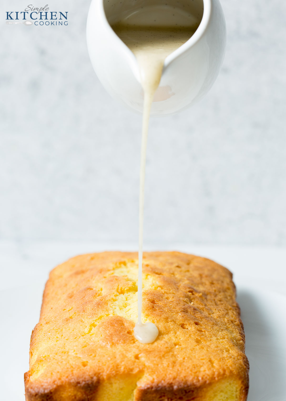 Drizzling the drizzle on the lemon drizzle cake