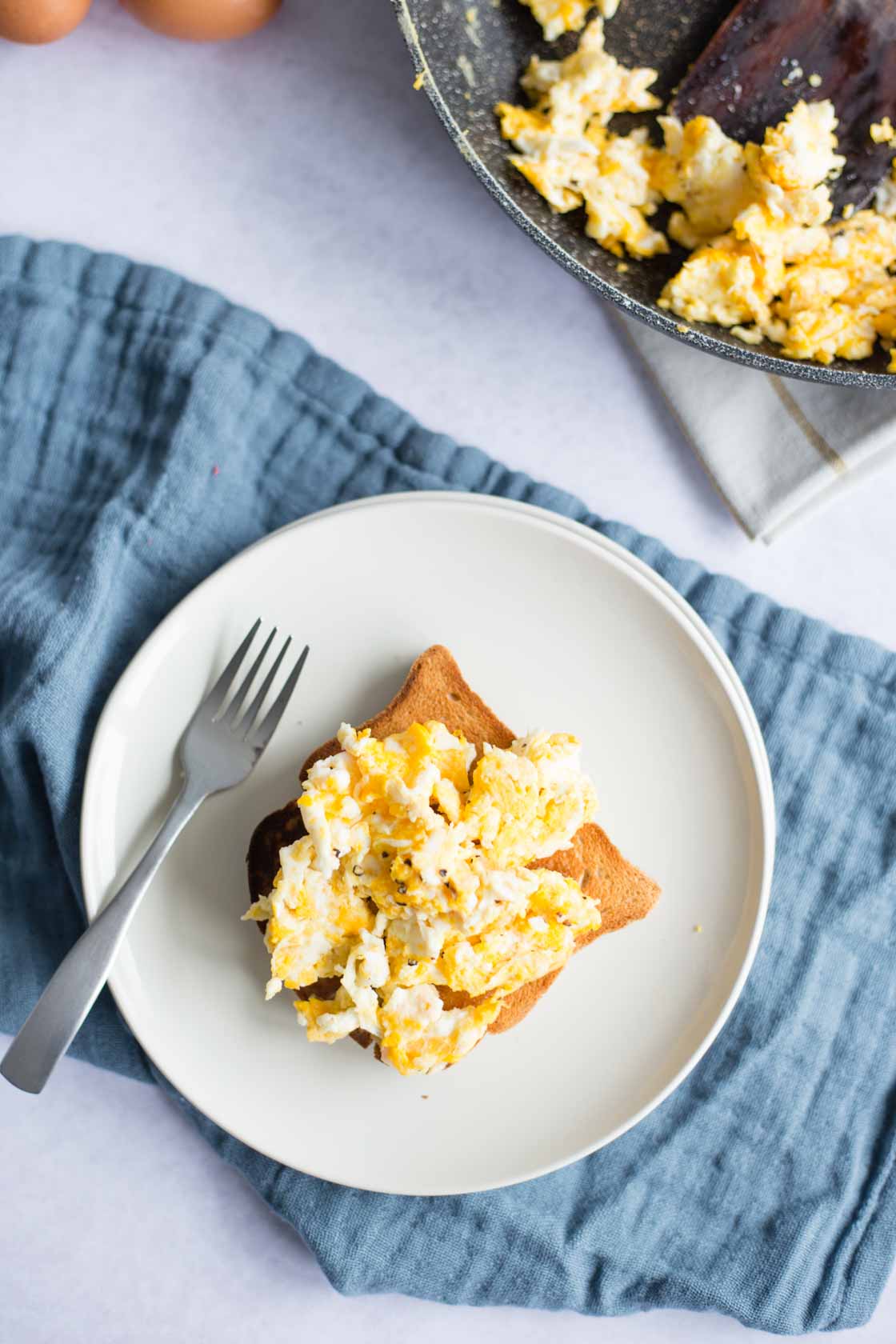 Looking above Scrambled Eggs on top of toast 